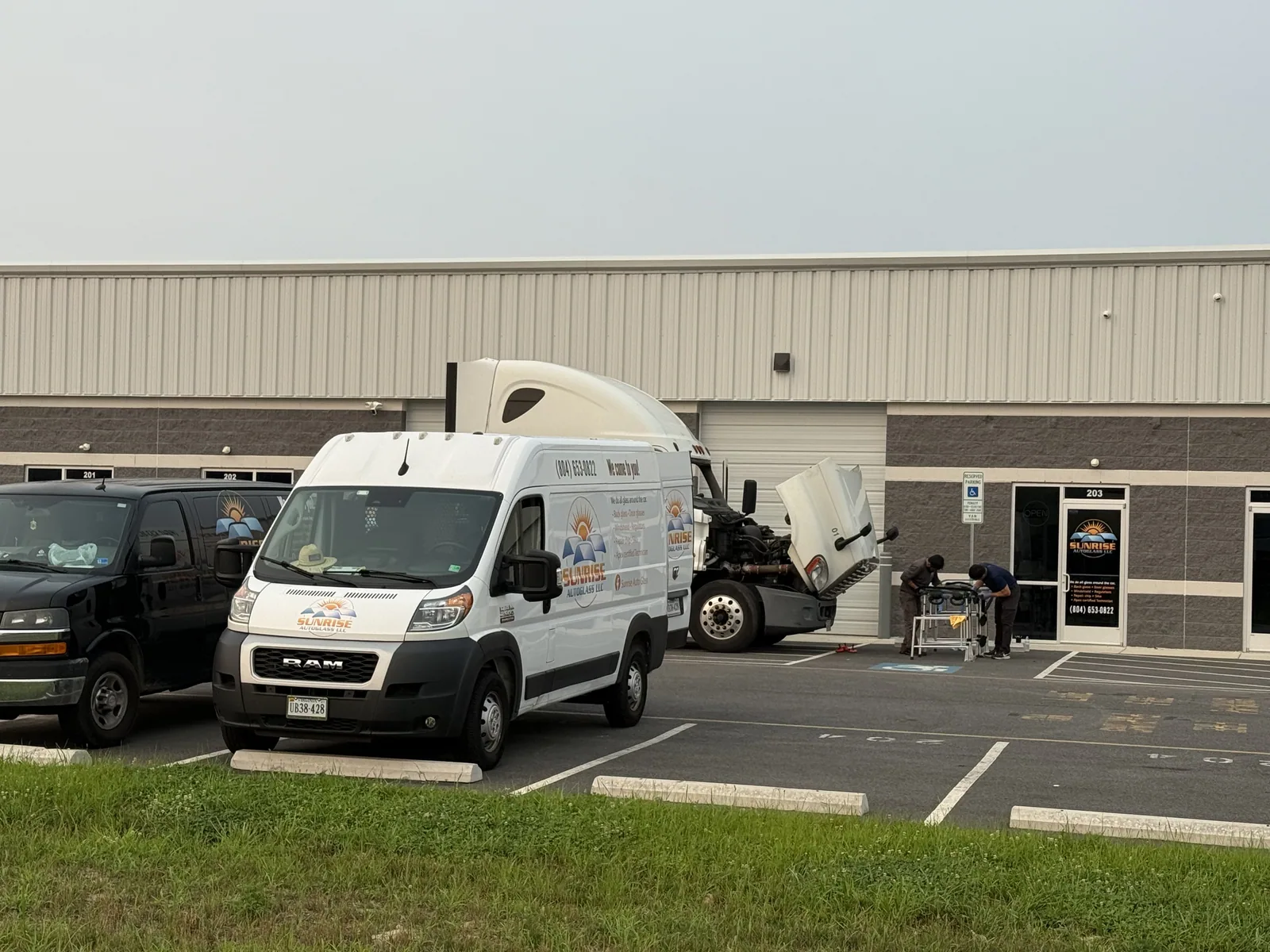 Sunrise AutoGlass vans parked outside the shop suite