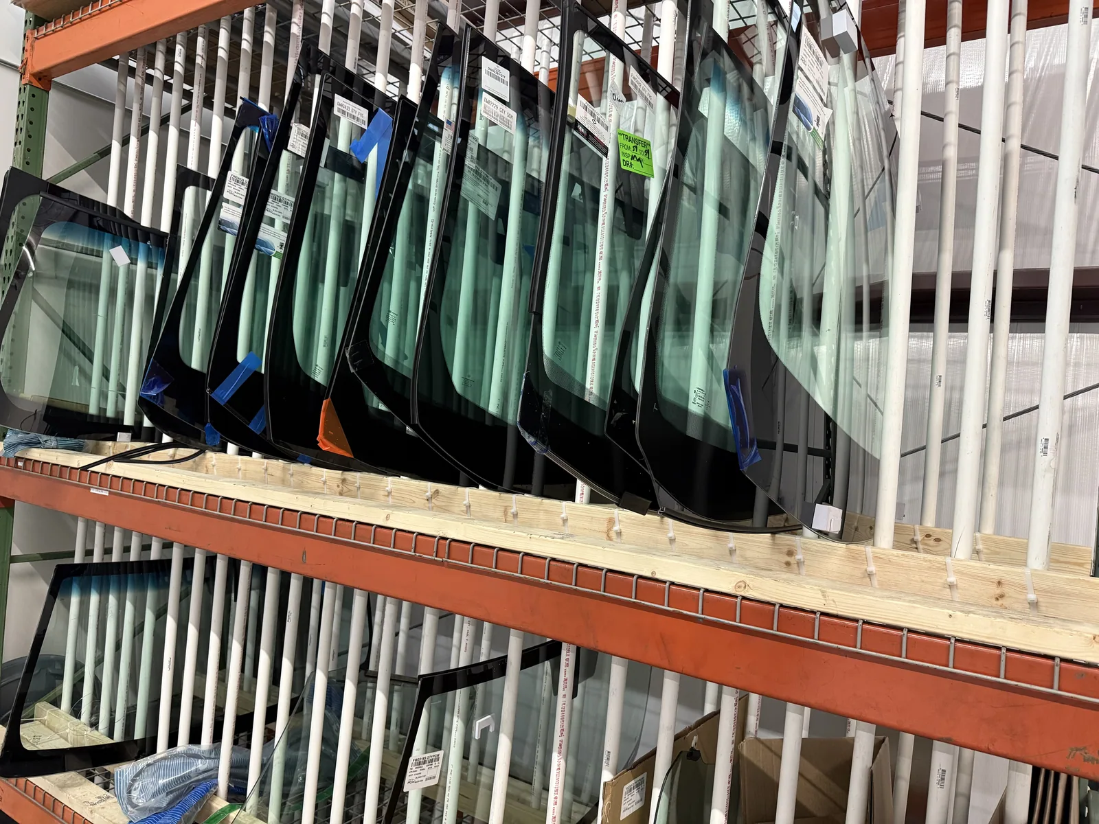 Windshields stored on racks inside the shop