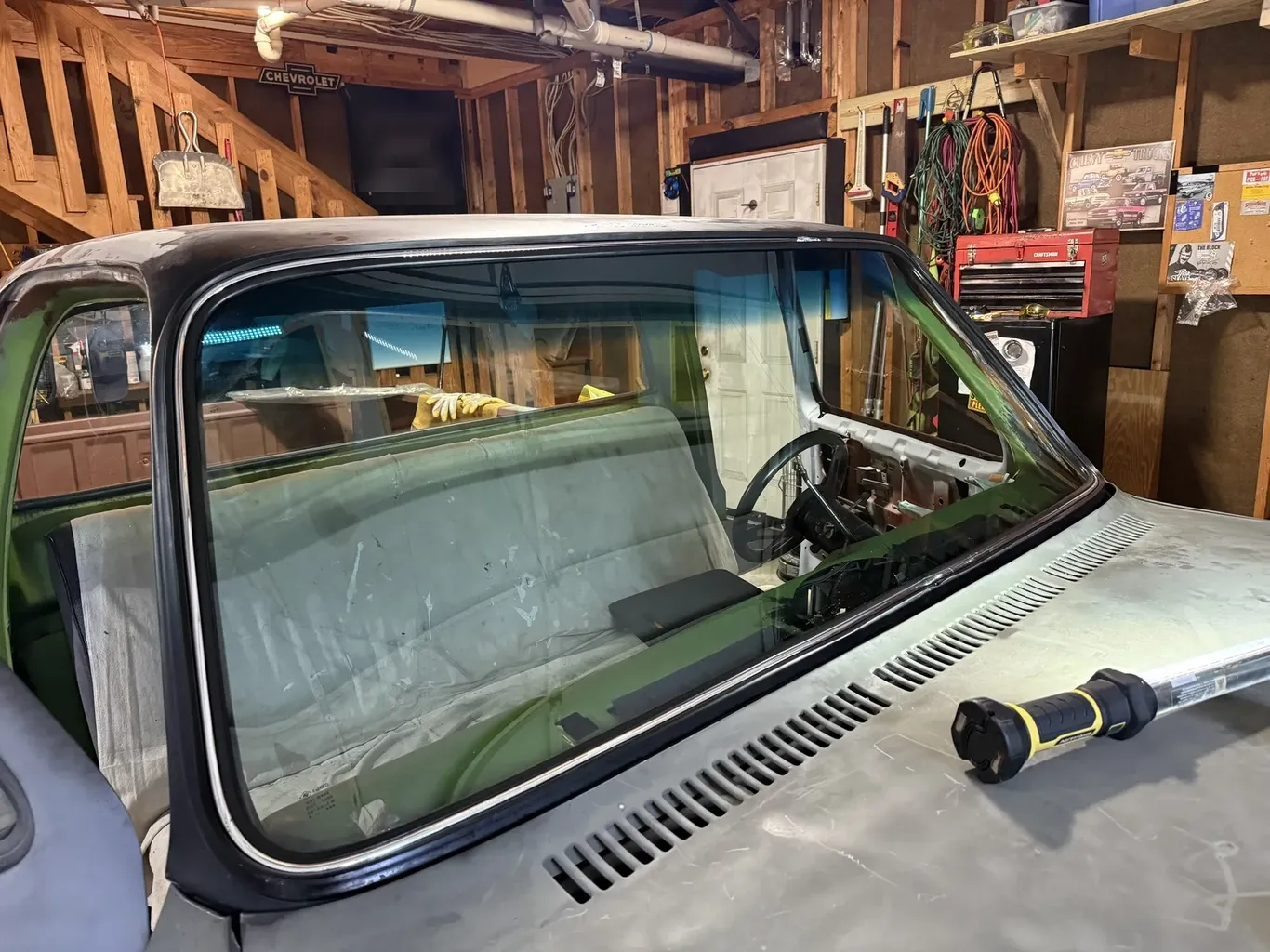 Classic car windshield opening prepared for new glass in the shop